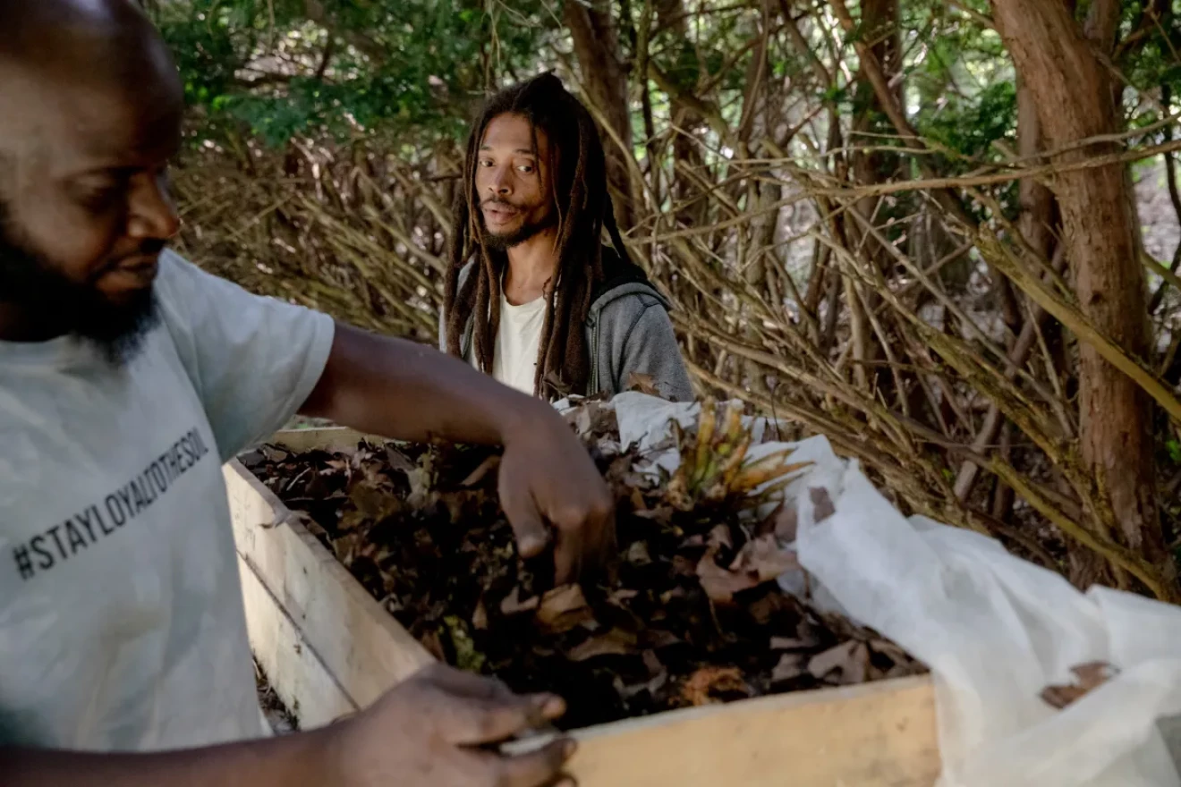 Richard Myers, left, and Shawn Joseph feed food scraps to worm castings, which in turn they use to fertilize their plants at the farm. “This way, we know we’ll be able to provide a product that is both fresher and safer as well,” Joseph said of his farm. “It feeds both ourselves and our community.”